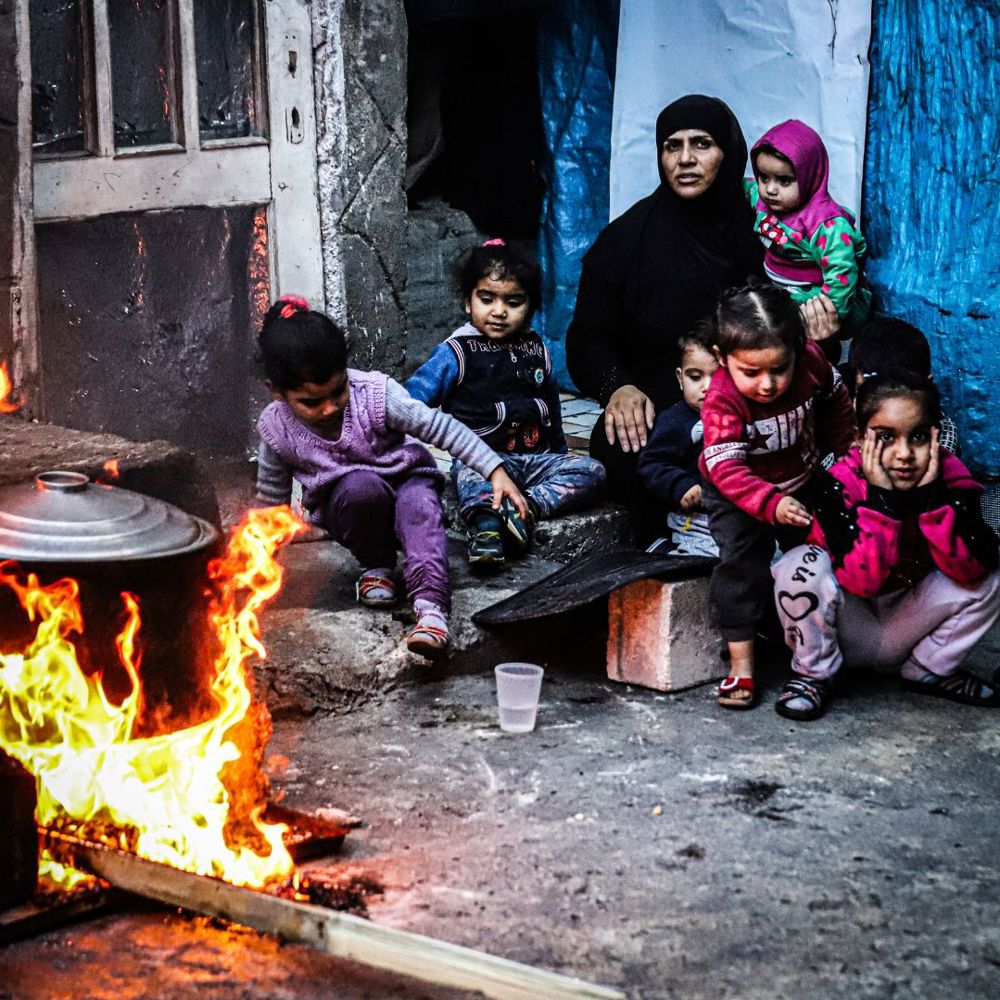 children staying warm with fire