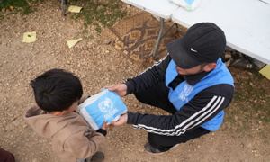 child receiving food aid from GRF in Lebanon