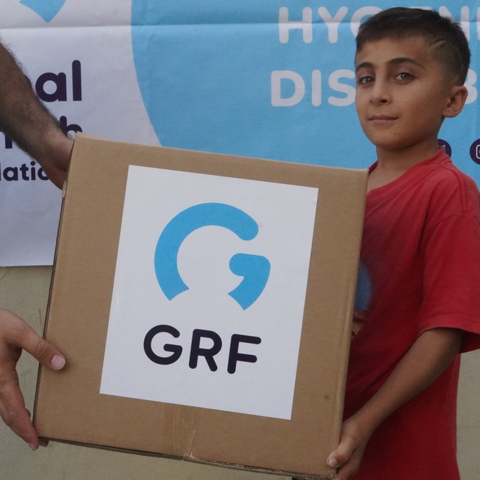 child holding aid box Lebanon 2024