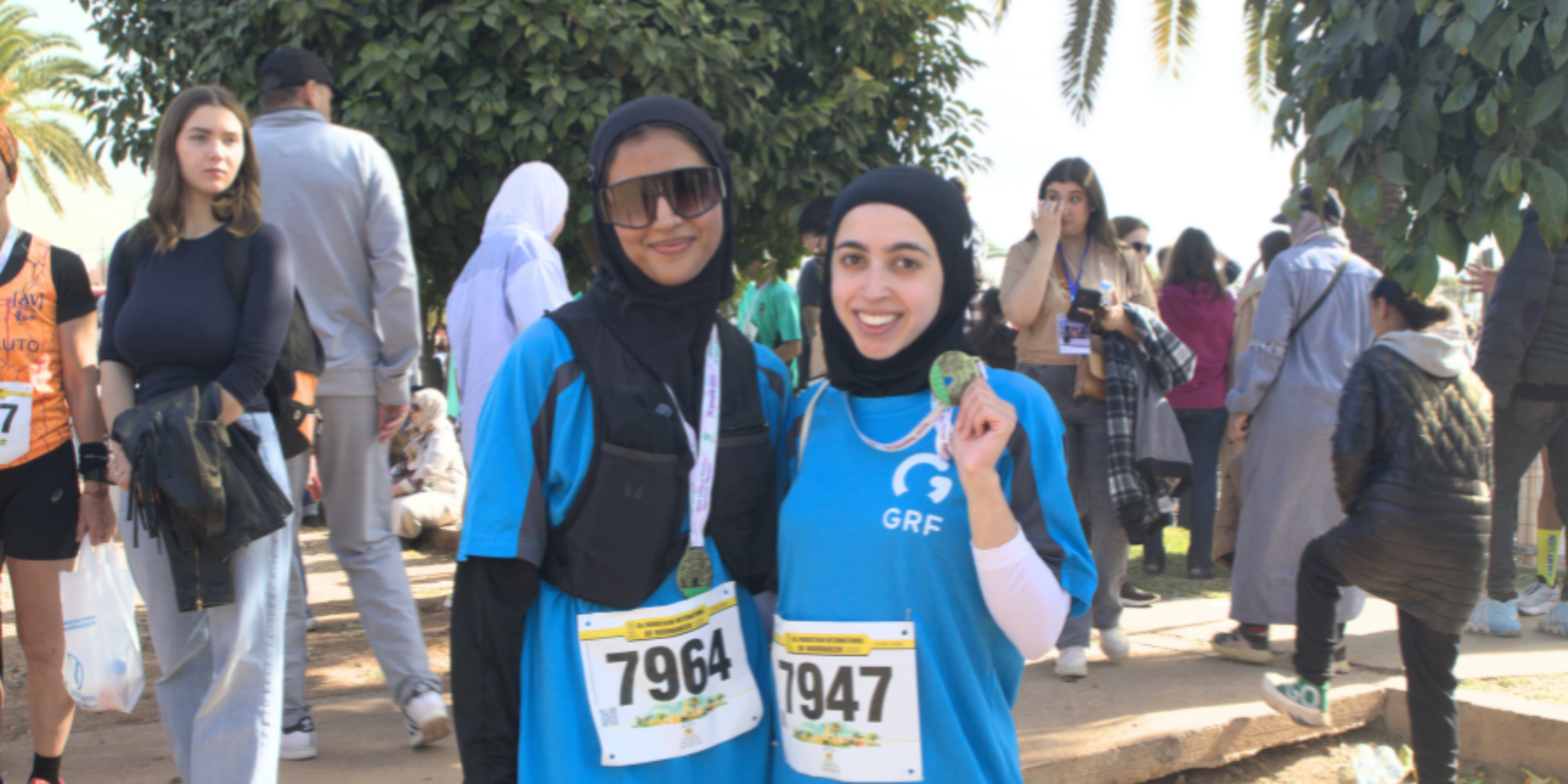 GRF runners holding medals after running Marrakech Marathon