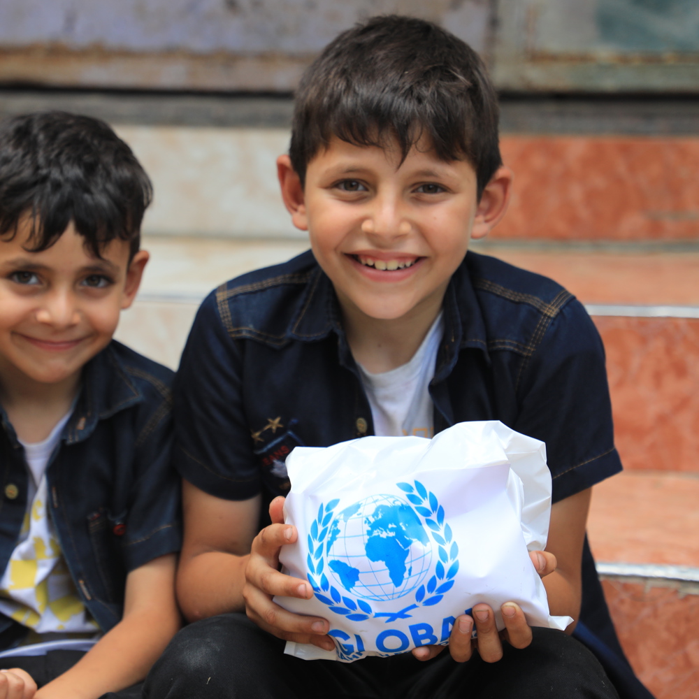 children holding Qurbani meat from GRF