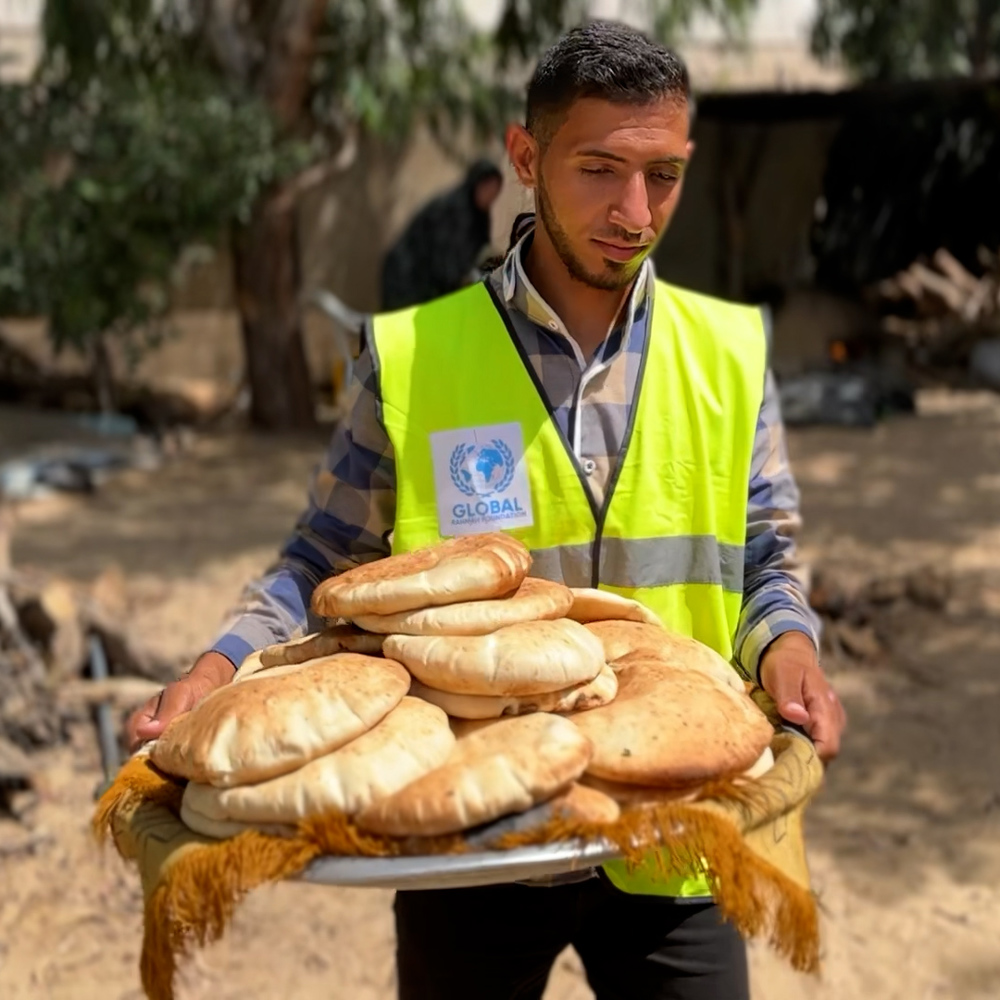 GRF team member holding baked bread