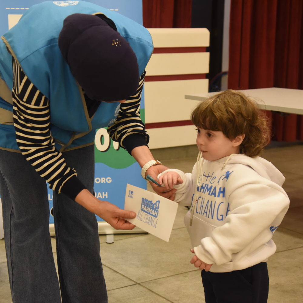 GRF team member giving child certificate
