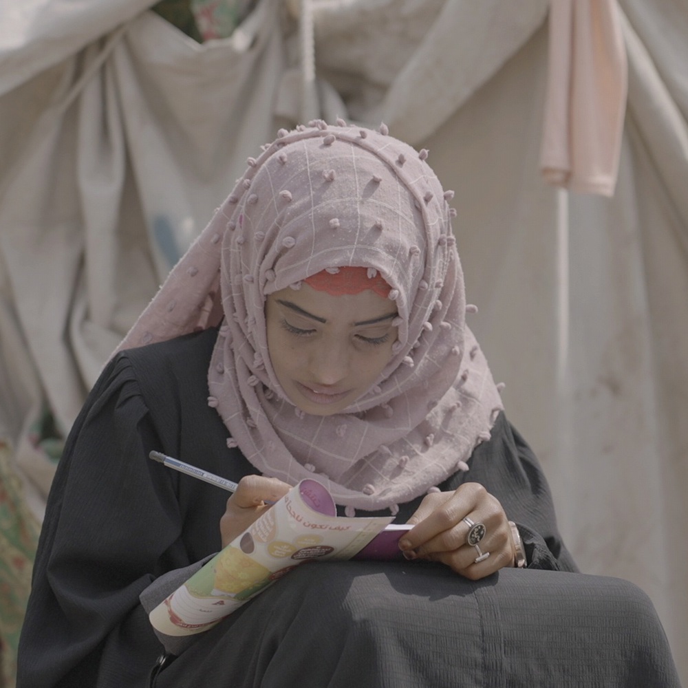 girl writing on notebook Yemen
