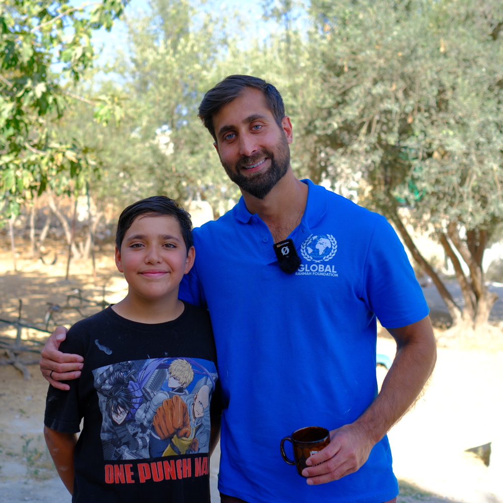 Dr Asif standing with young child on GRF Islamic charity deployment in Jordan 2024
